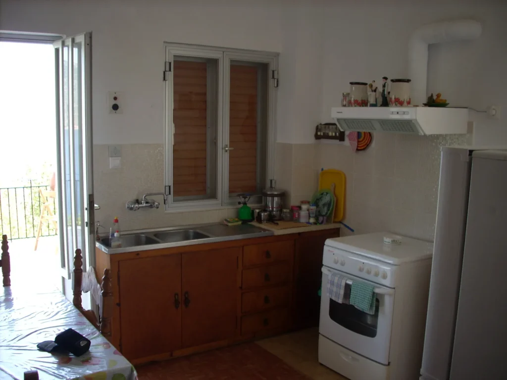Apartment kitchen with balcony door at Olympia House