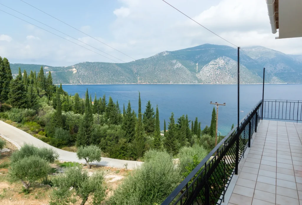Balcony view over the Ionian Sea and cypress trees