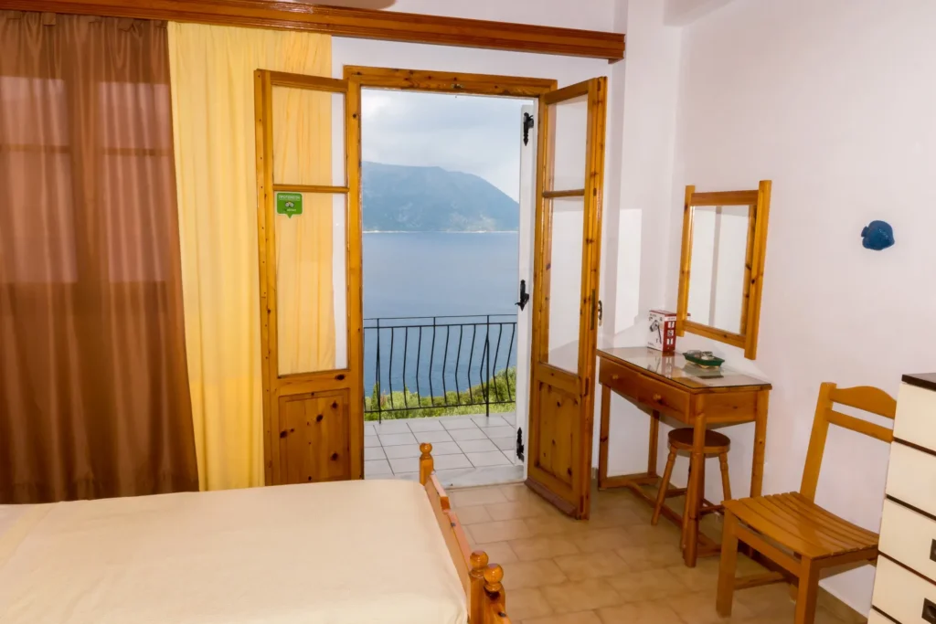Bedroom with balcony door and sea view
