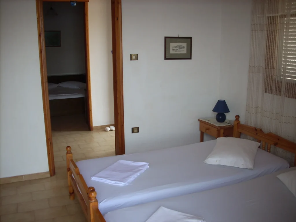 Bedroom with single beds and a view of the hallway