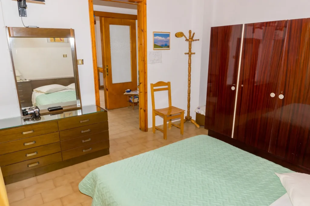 Bedroom with wardrobe, dresser and mirror