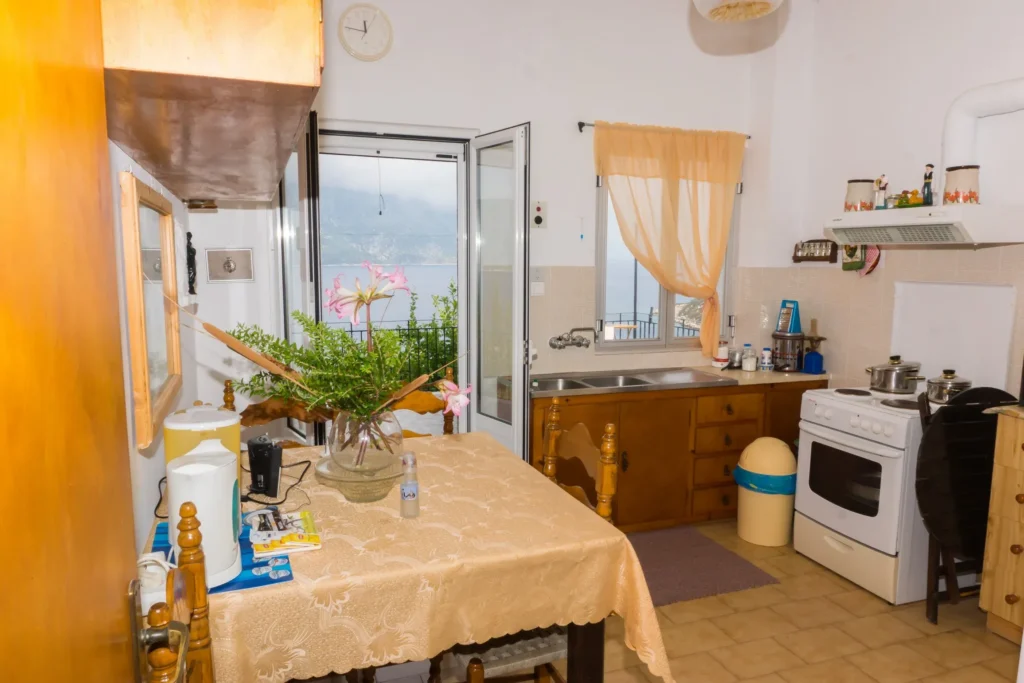 Bright kitchen with dining table and balcony door