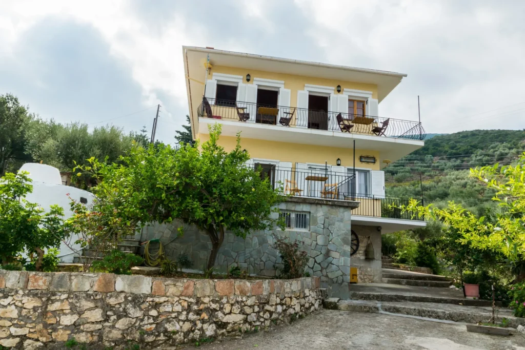 Olympia House, a two-storey guesthouse with balconies in Vathy, Ithaca