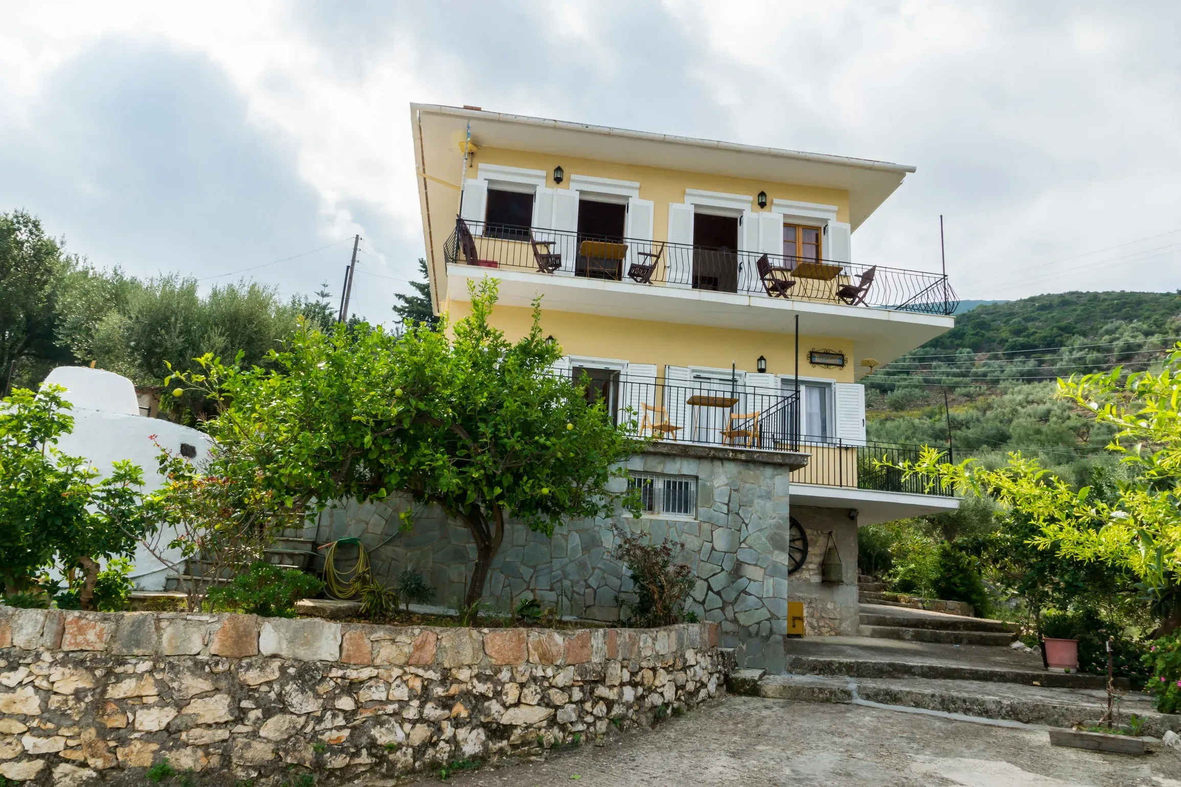 Olympia House, a two-storey guesthouse with balconies in Vathy, Ithaca