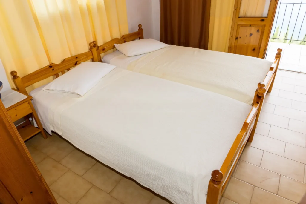 Second Floor Apartment: twin bedroom with balcony door