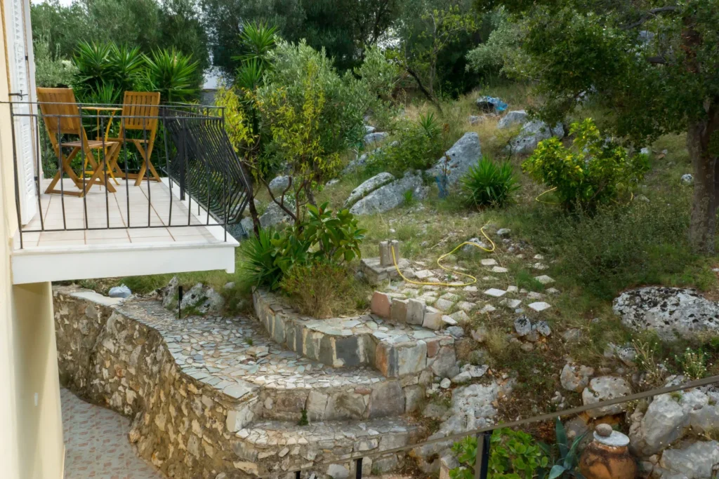 Stone steps in the garden and a balcony with chairs