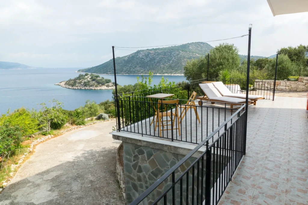Terrace with sun loungers above the sea